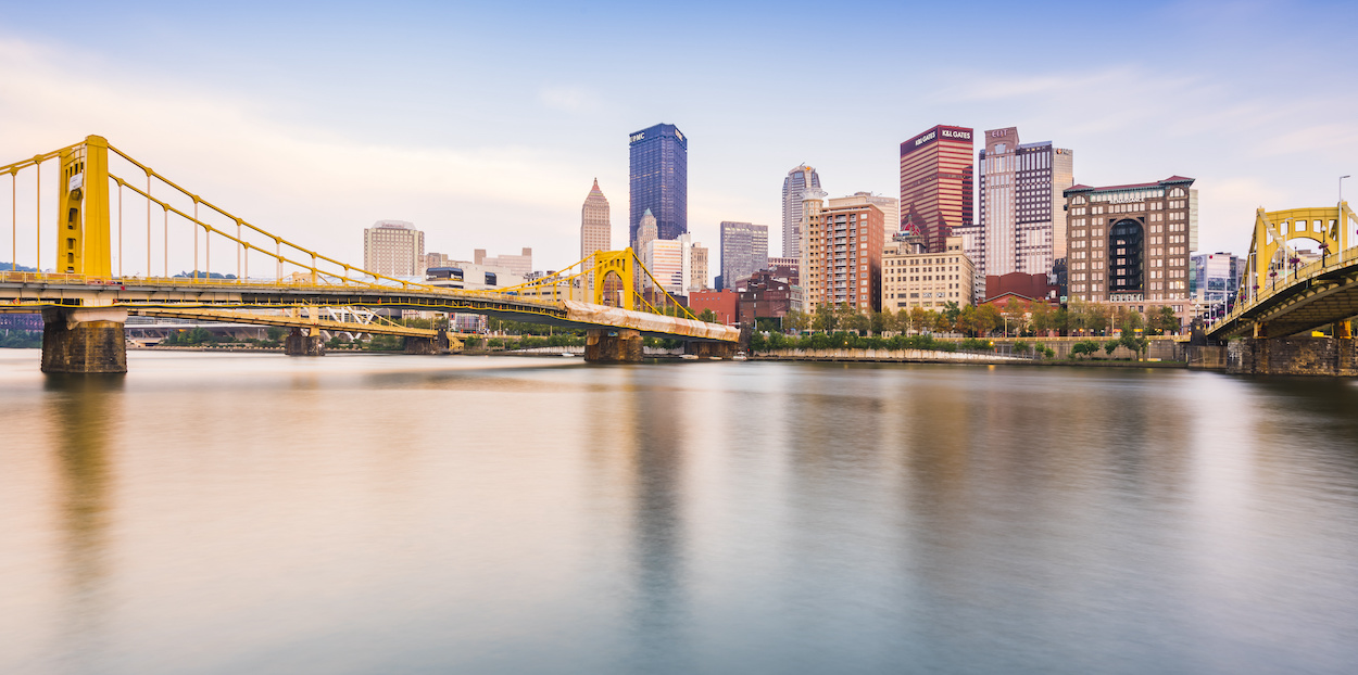 pittsburgh,pennsylvania,usa : 8-21-17. pittsburgh skyline at sunset with reflection in the water.