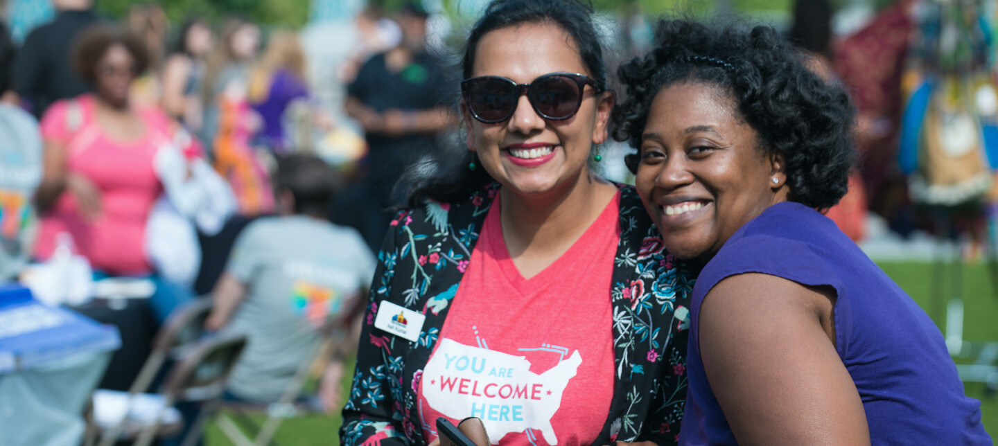 Two women smiling at a Welcoming Week event in Decatur, Georgia.